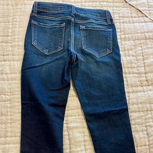 Girls KanCan skinny jeans with frayed edges. Adjustable waist.